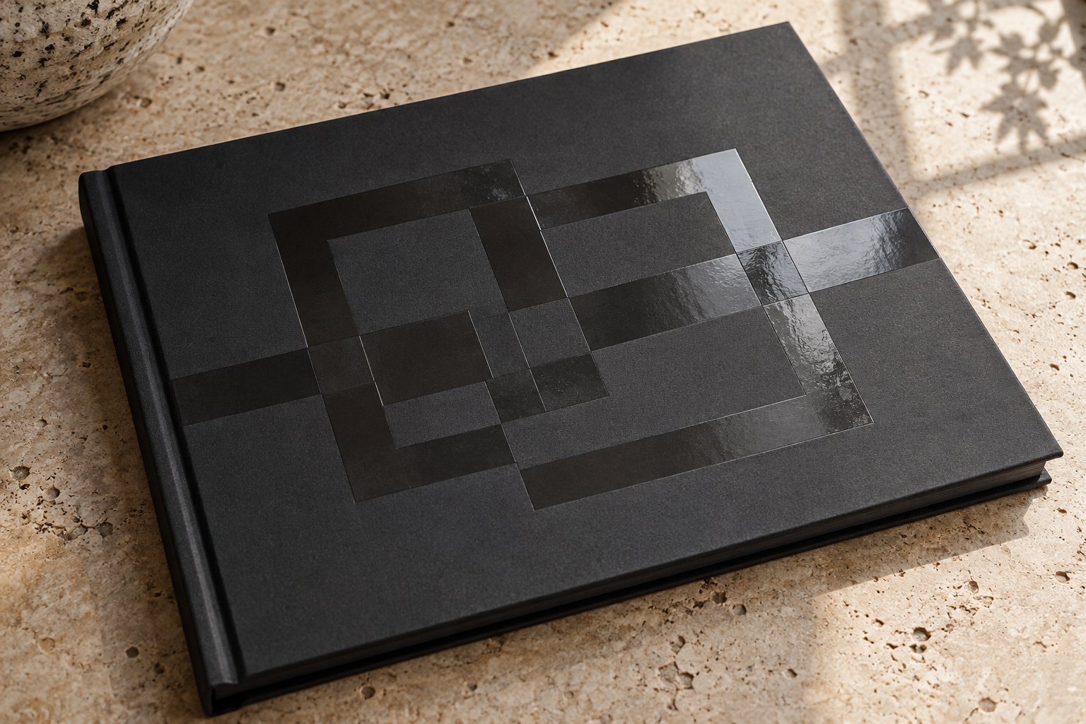 Clear gloss spot UV pattern catching light on a matte charcoal cover